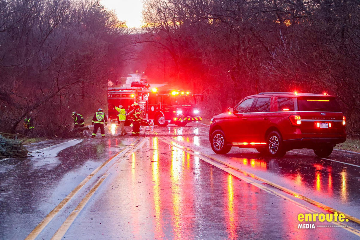 Firefighters cleaning up the road after a car crash